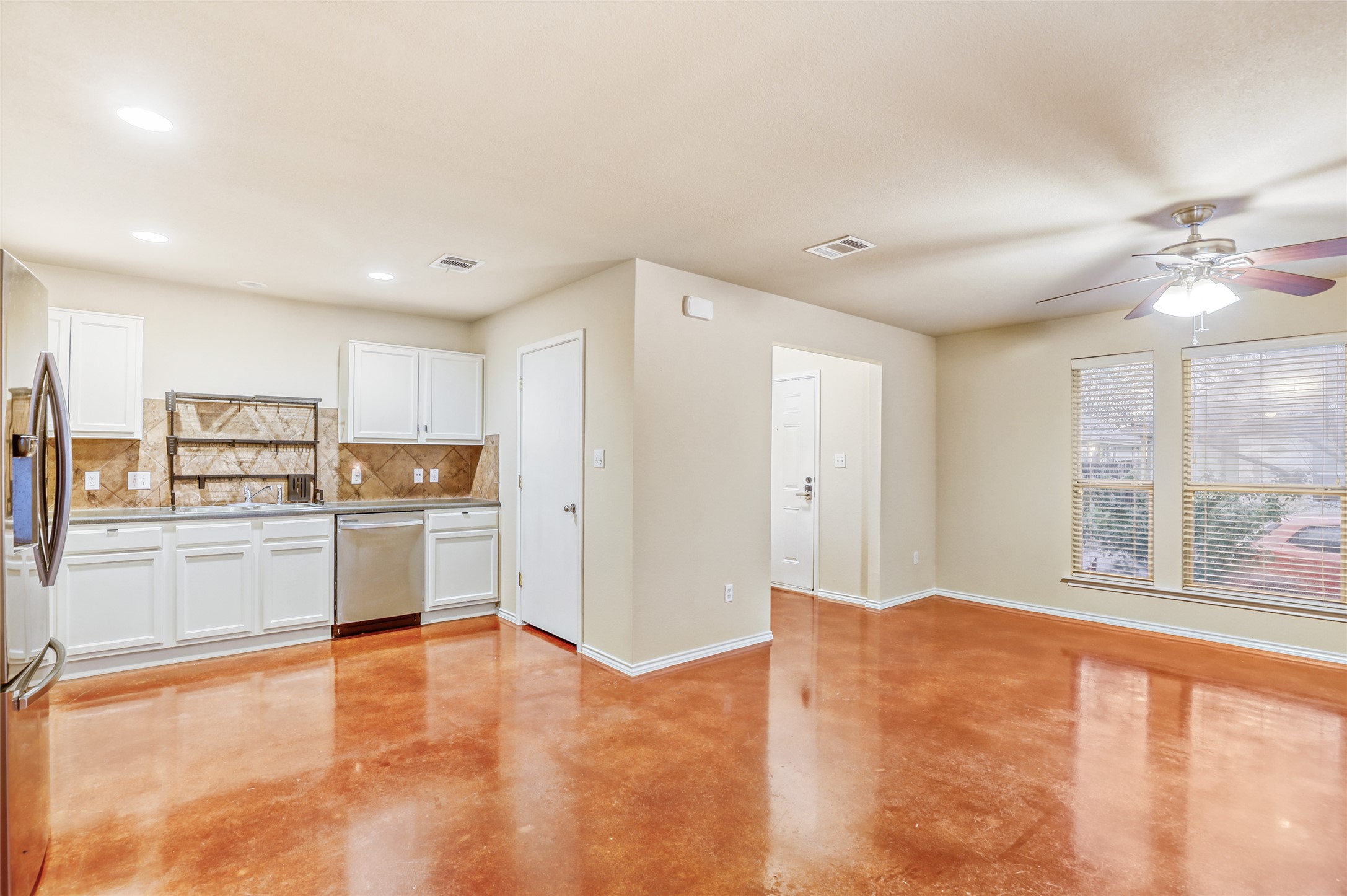 4620 Best Way Austin, TX 78725 - Photo 6 of 11 a living room with stainless steel appliances kitchen island granite countertop a refrigerator and a stove top oven