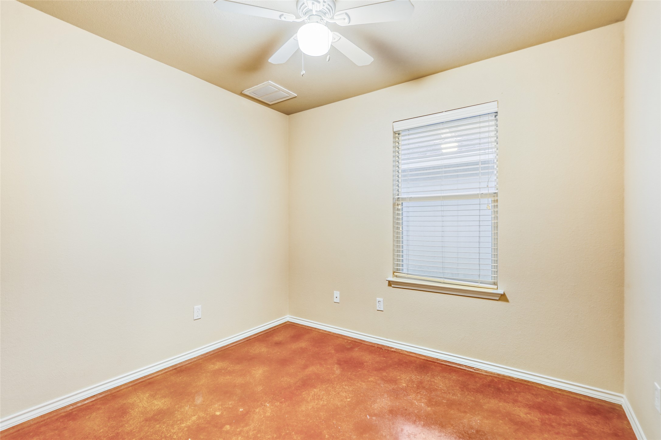 4620 Best Way Austin, TX 78725 - Photo 7 of 11 an empty room with a chandelier fan and windows