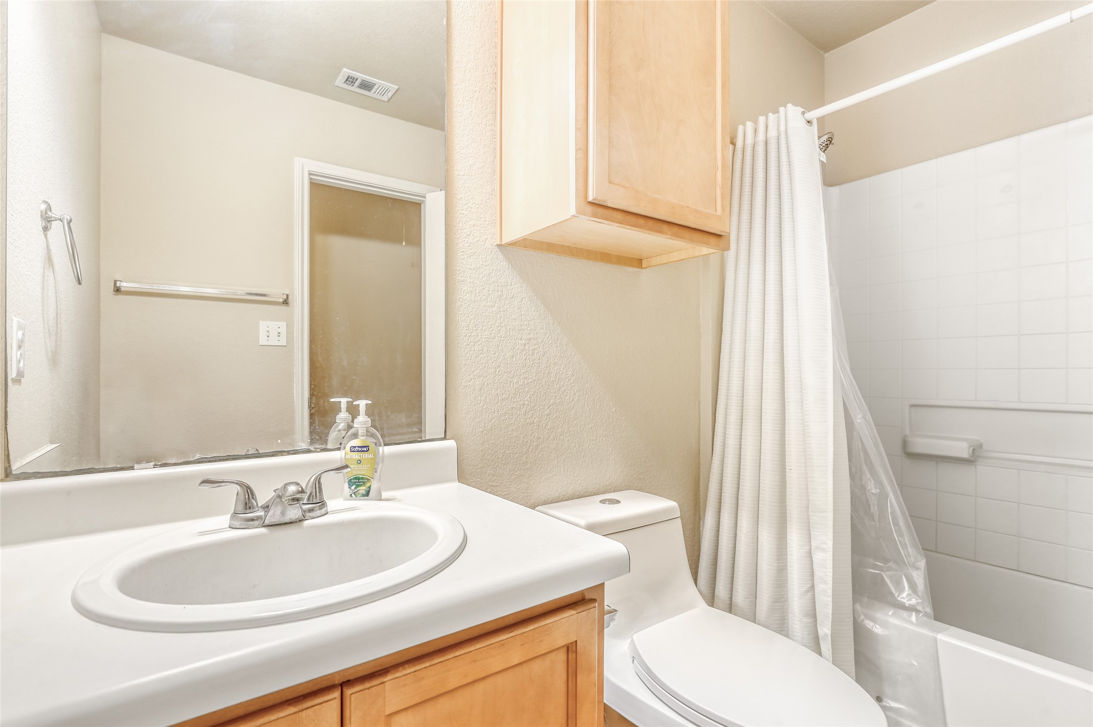 4620 Best Way Austin, TX 78725 - Photo 9 of 11 a bathroom with a sink a toilet a mirror and shower