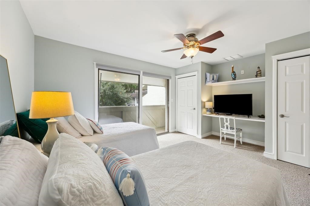 3033 Sea Marsh Road Fernandina Beach, FL 32034 - Photo 20 of 37 a bedroom with a bed and a flat screen tv