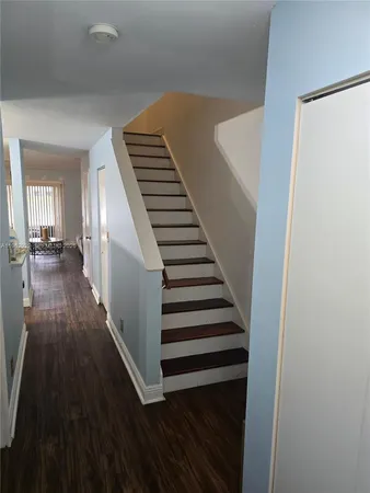 a view of a hallway with wooden floor and entryway