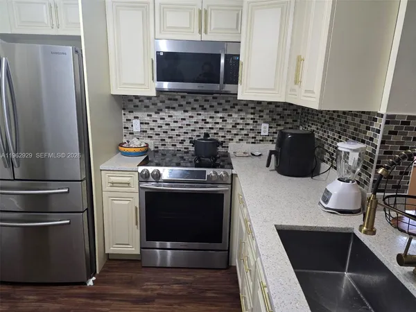 a kitchen with a stove and a refrigerator
