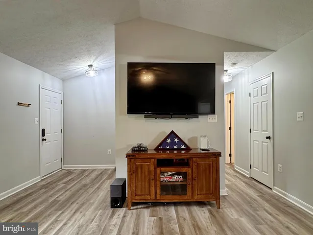 a kitchen with stainless steel appliances granite countertop a stove top oven a sink and a refrigerator