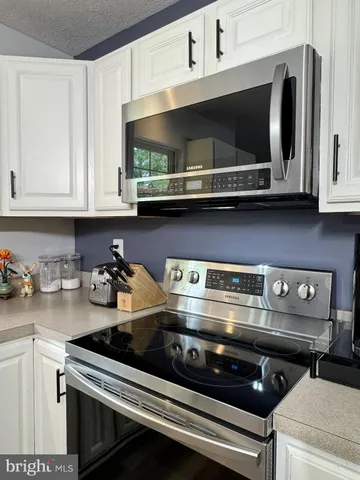 a spacious bedroom with a bed and a chandelier