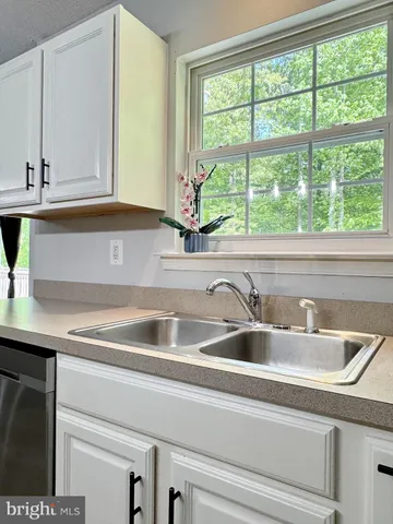 a bathroom with a bathtub double sink and mirror