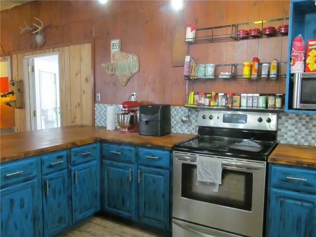 a kitchen with stainless steel appliances granite countertop a stove and cabinets