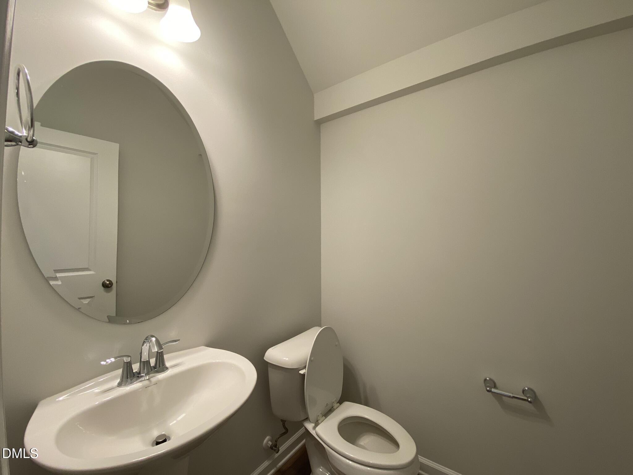 218 Loxton Street Fuquay-Varina, NC 27526 - Photo 11 of 37 a bathroom with a sink mirror and toilet