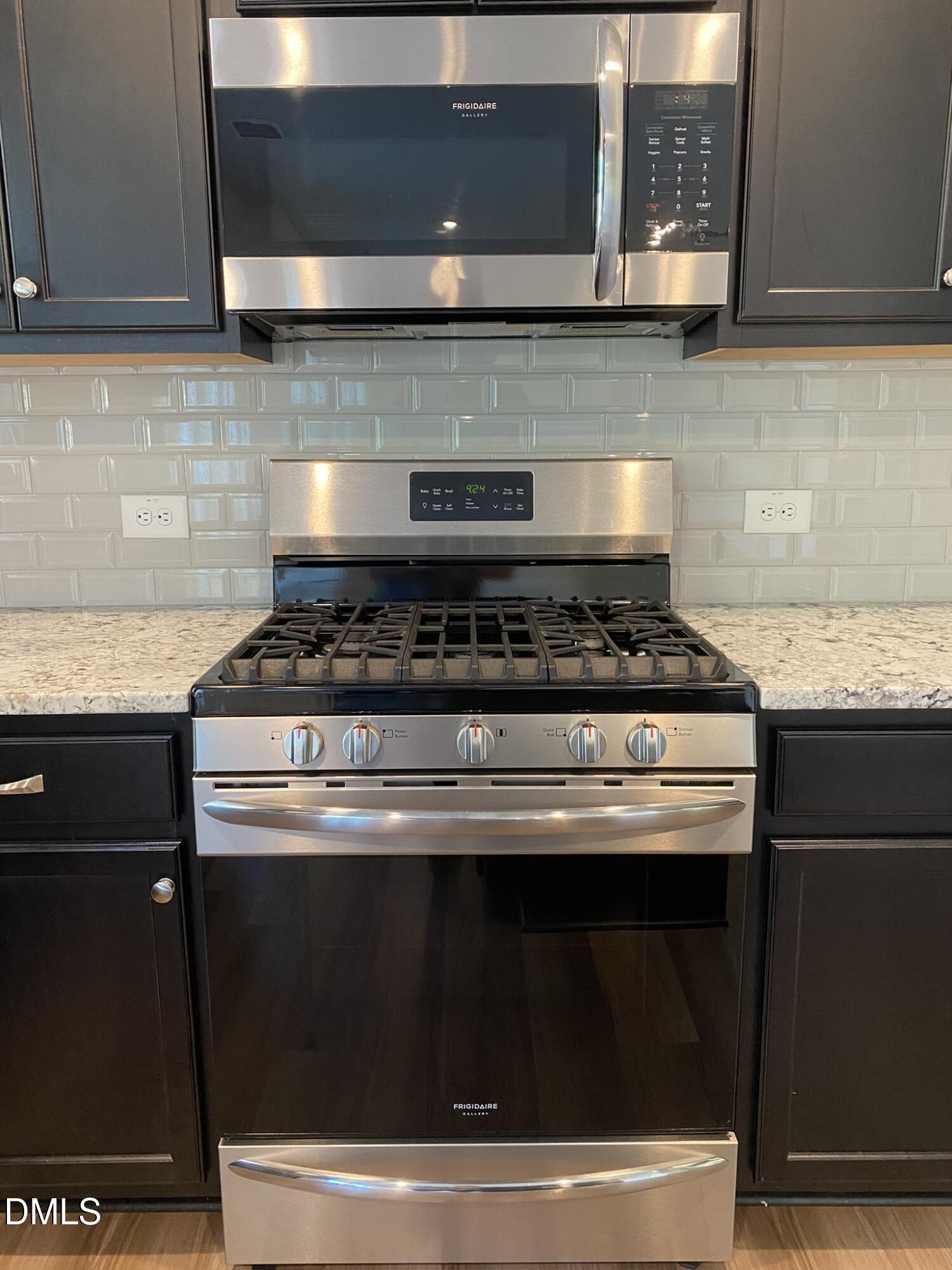 218 Loxton Street Fuquay-Varina, NC 27526 - Photo 12 of 37 a stove top oven sitting inside of a kitchen