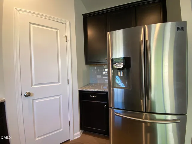 a metallic refrigerator freezer and a refrigerator in a kitchen