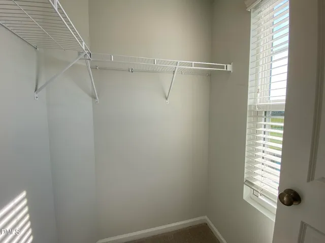 a view of a room with rack on the wall and a window