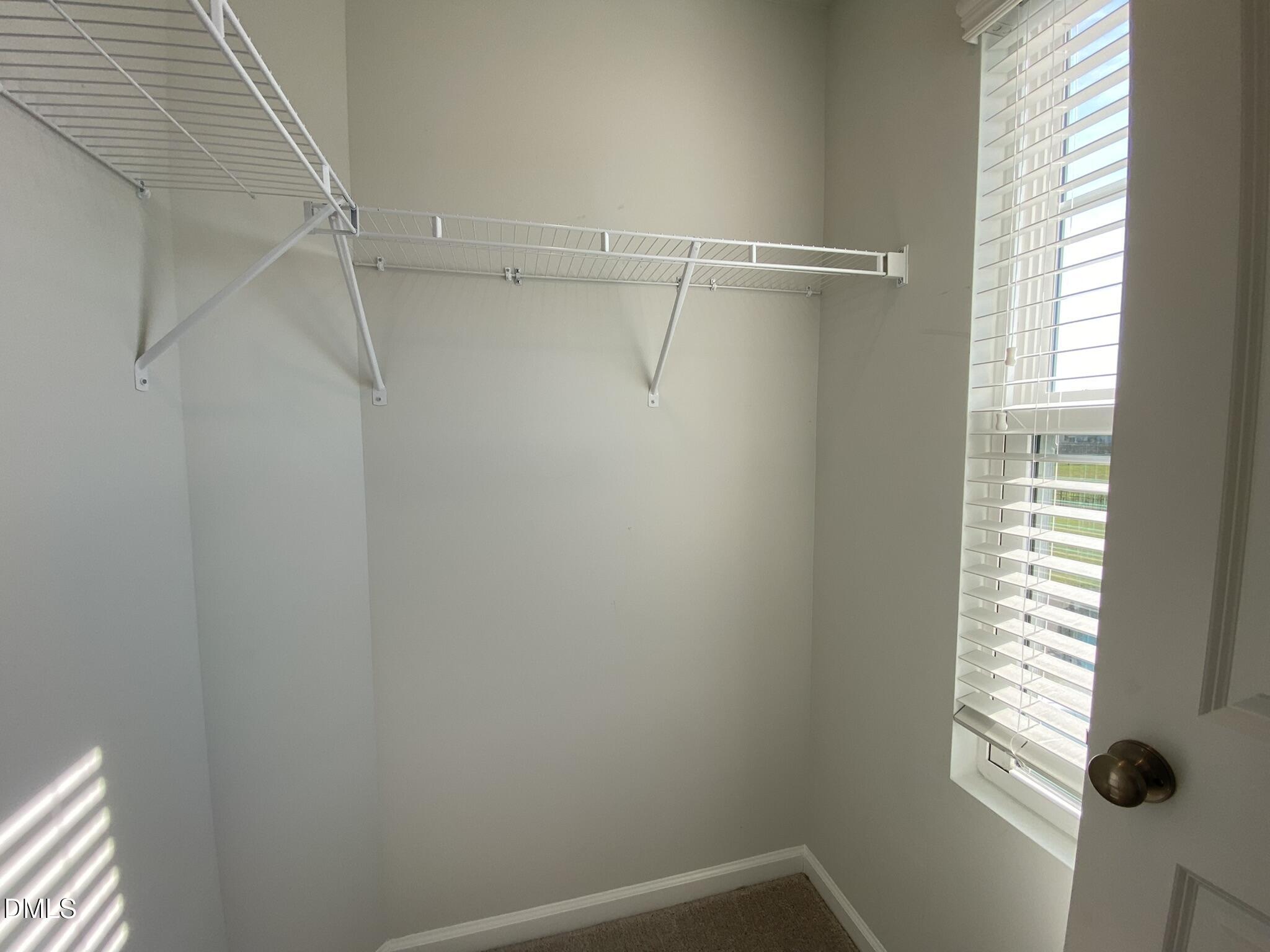 218 Loxton Street Fuquay-Varina, NC 27526 - Photo 20 of 37 a view of a room with rack on the wall and a window