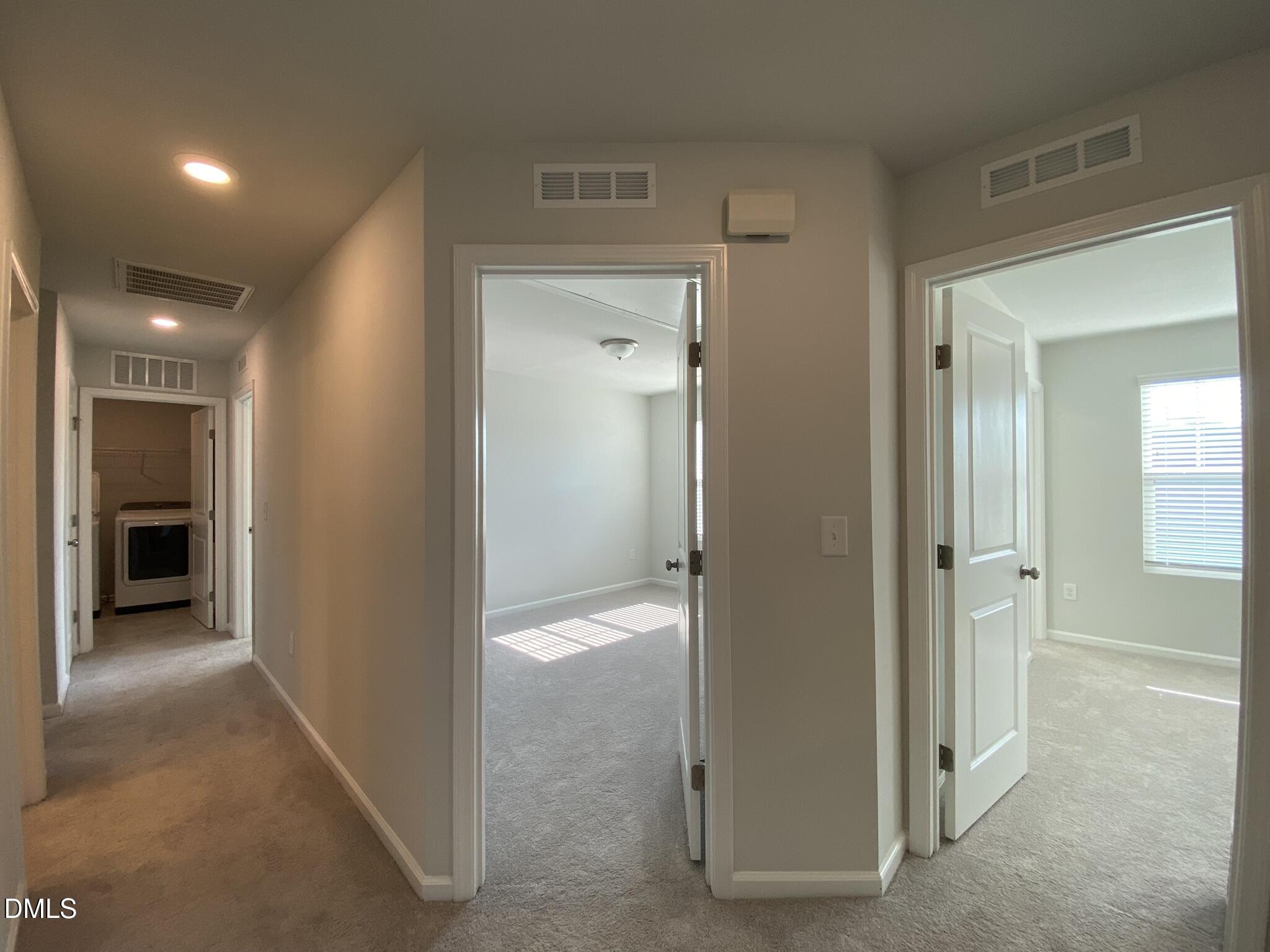 218 Loxton Street Fuquay-Varina, NC 27526 - Photo 21 of 37 a view of a hallway with wooden shelves