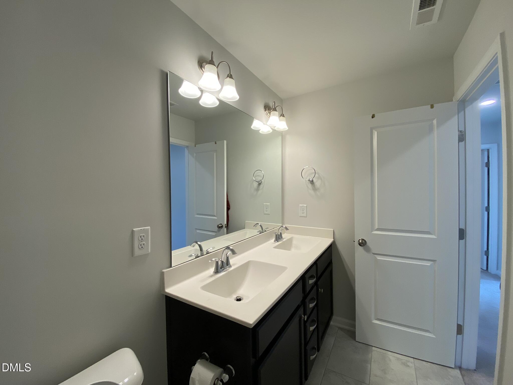 218 Loxton Street Fuquay-Varina, NC 27526 - Photo 23 of 37 a bathroom with a sink and a mirror