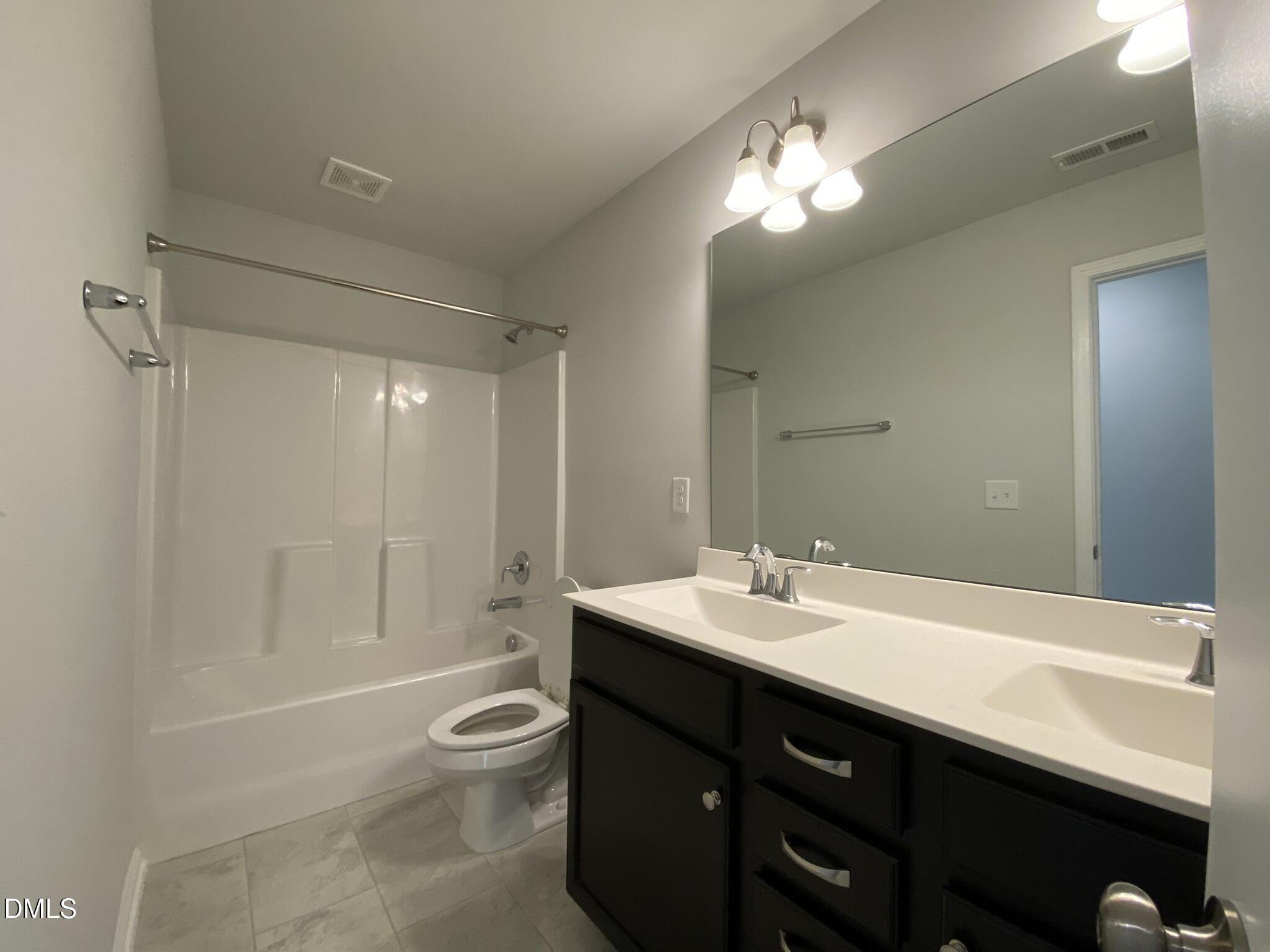 218 Loxton Street Fuquay-Varina, NC 27526 - Photo 24 of 37 a bathroom with a sink a toilet and shower
