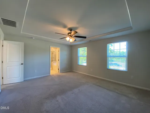 a view of a livingroom with a ceiling fan and window