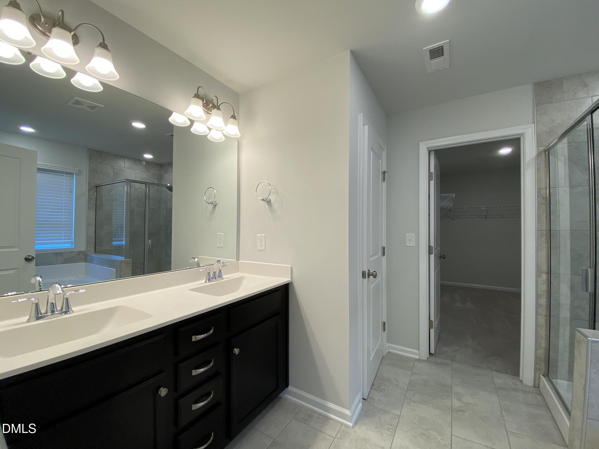 218 Loxton Street Fuquay-Varina, NC 27526 - Photo 28 of 37 a bathroom with a double vanity sink and a mirror