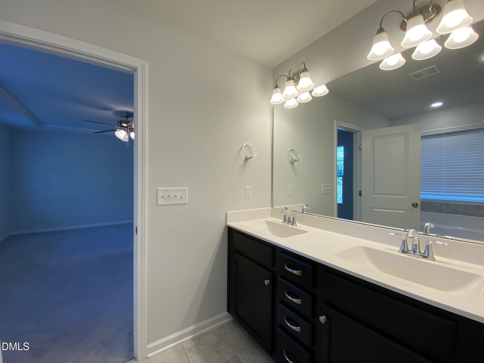 218 Loxton Street Fuquay-Varina, NC 27526 - Photo 29 of 37 a bathroom with a double vanity sink and a mirror