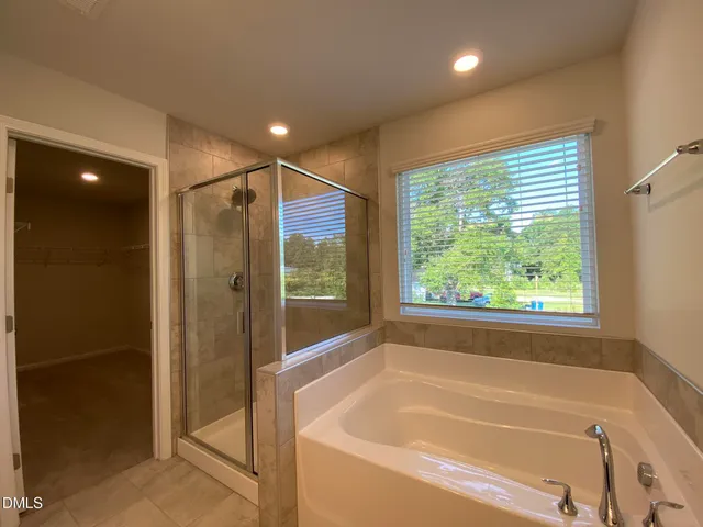a bathroom with a bathtub and shower