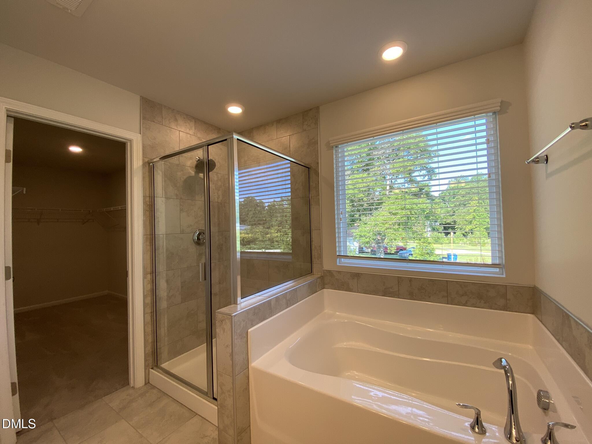 218 Loxton Street Fuquay-Varina, NC 27526 - Photo 31 of 37 a bathroom with a bathtub and shower