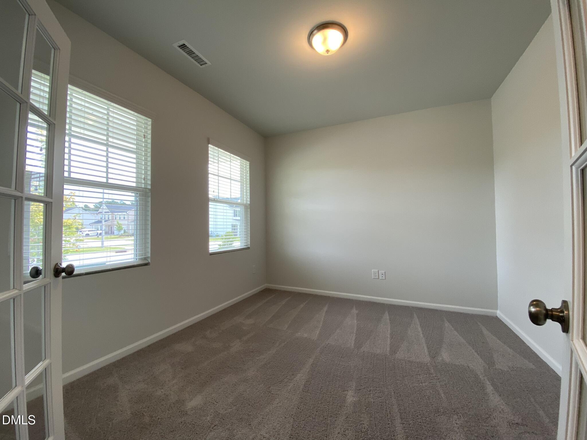 218 Loxton Street Fuquay-Varina, NC 27526 - Photo 5 of 37 an empty room with windows