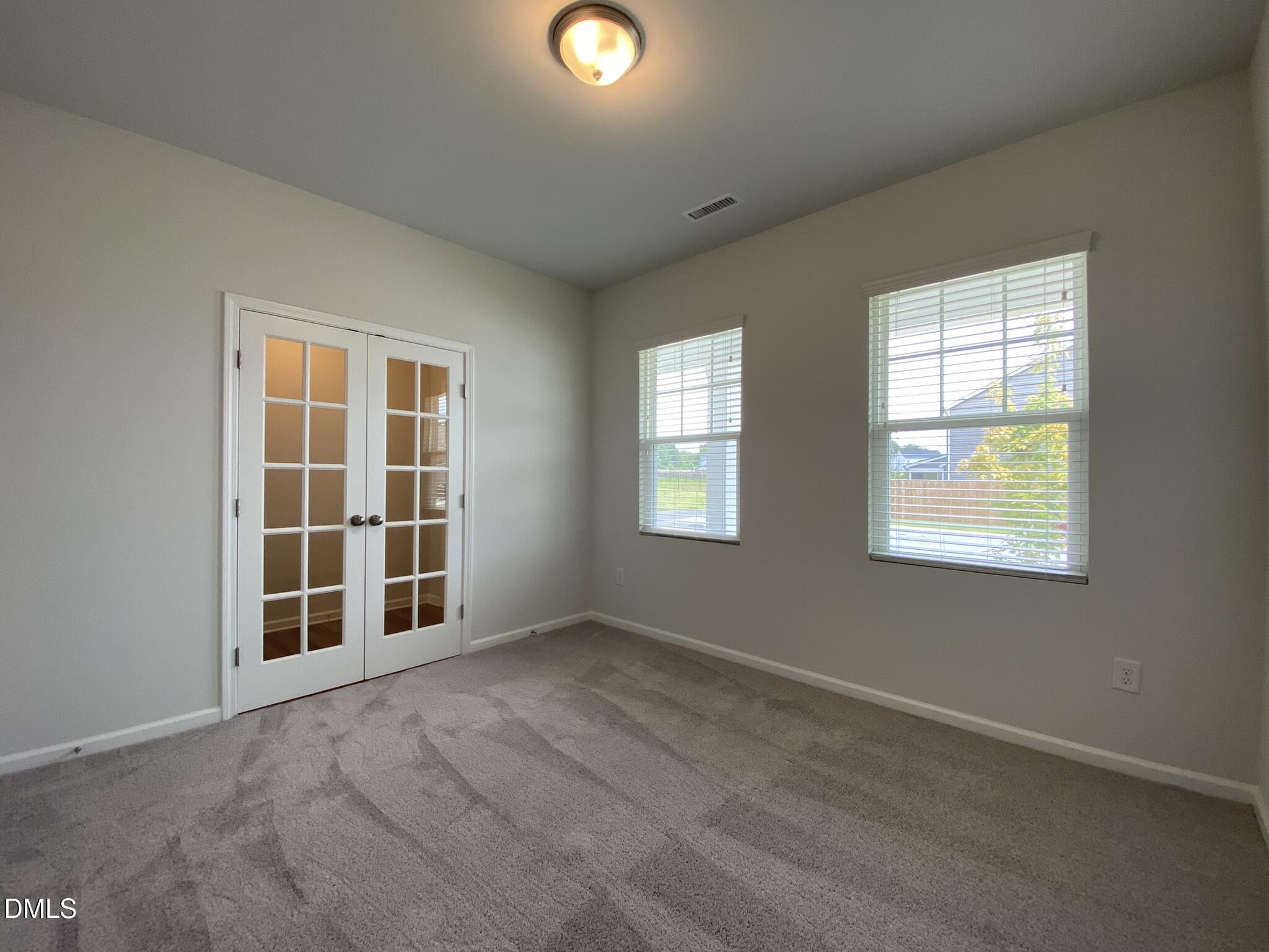218 Loxton Street Fuquay-Varina, NC 27526 - Photo 6 of 37 an empty room with windows