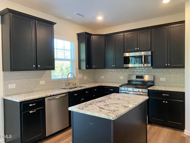 a kitchen with a sink and a microwave