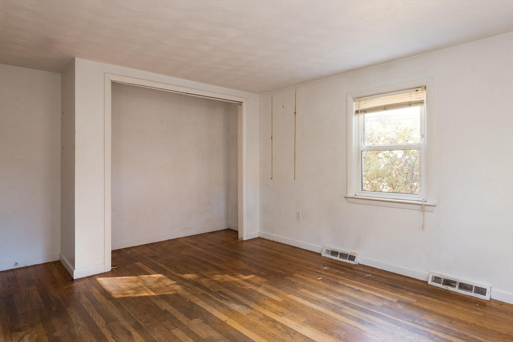 25 Lawrence Road Halifax, MA 02338 - Photo 12 of 22 a view of empty room with wooden floor and fan