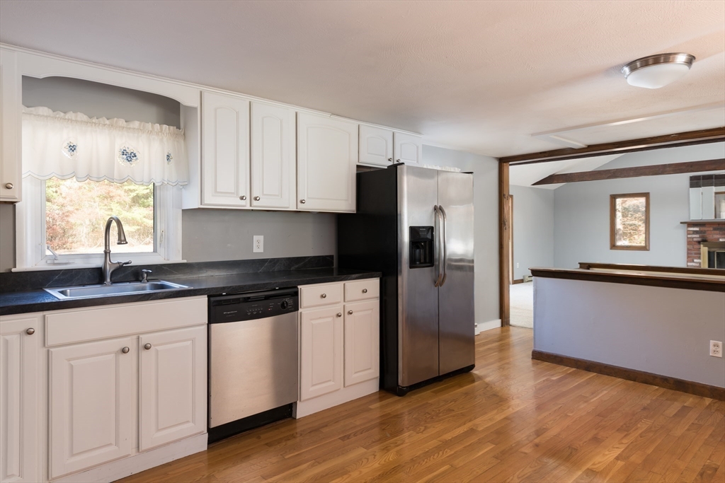 25 Lawrence Road Halifax, MA 02338 - Photo 5 of 22 a kitchen with granite countertop white cabinets white appliances and sink