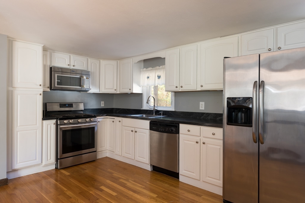 25 Lawrence Road Halifax, MA 02338 - Photo 6 of 22 a kitchen with granite countertop a refrigerator stove and microwave