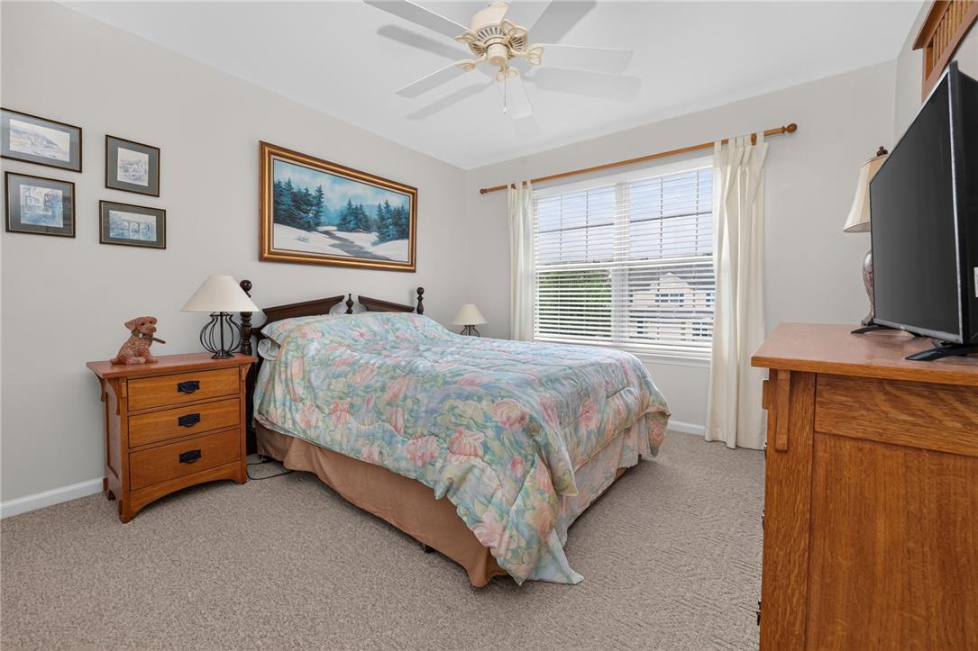 198 Park Ridge Drive Easton, PA 18040 - Photo 15 of 28 Relax in this tranquil bedroom, featuring a large window, inviting carpet, and a ceiling fan for ultimate comfort.