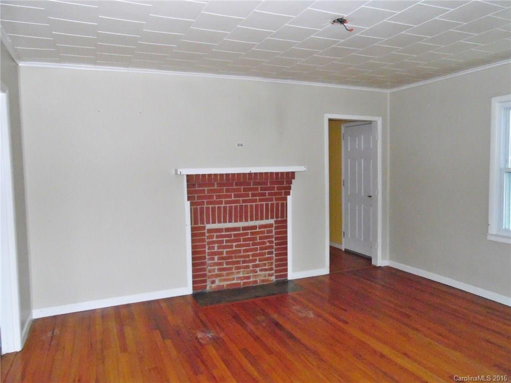 2106 Pinckney Road Chester, SC 29706 - Photo 11 of 18 an empty room with wooden floor and windows