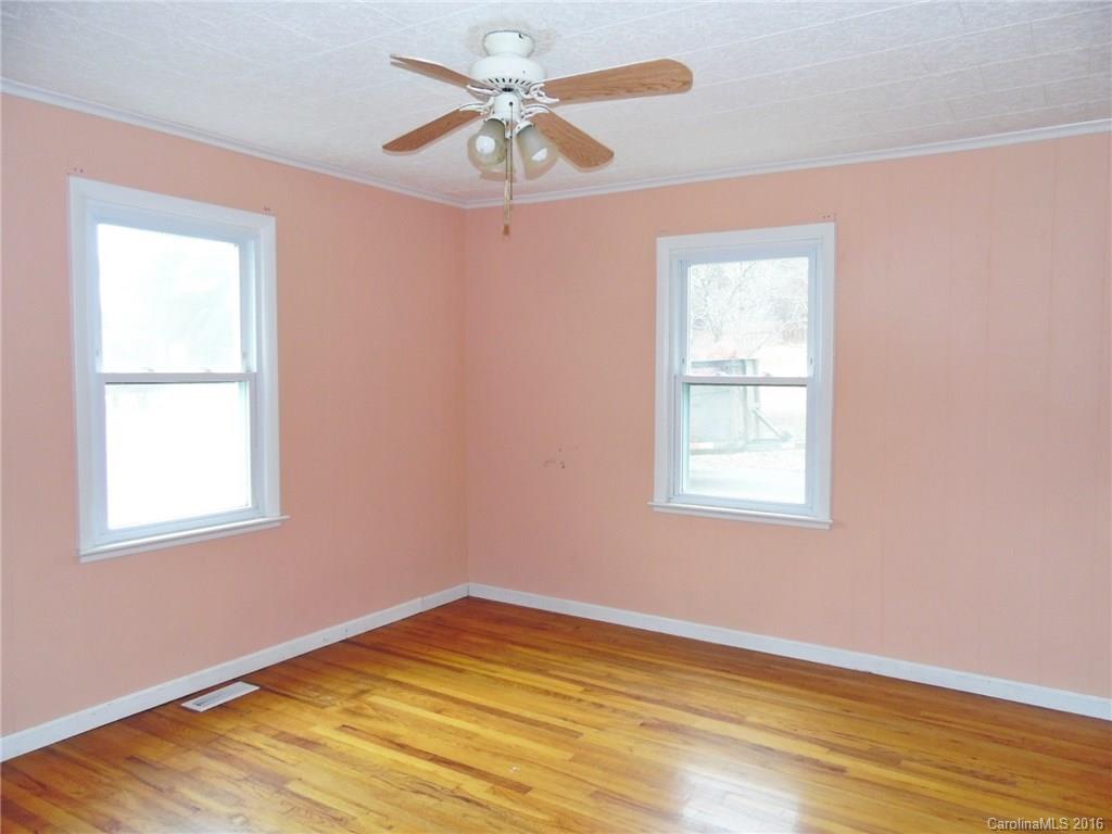 2106 Pinckney Road Chester, SC 29706 - Photo 3 of 18 an empty room with a window and wooden floor