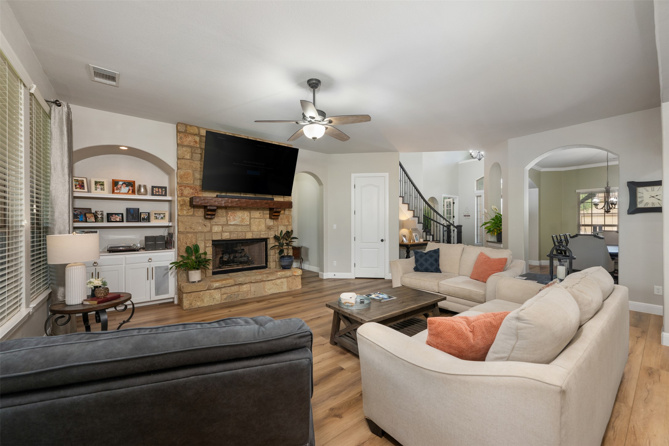 3021 Wedgescale Pass Leander, TX 78641 - Photo 7 of 40 a living room with furniture a flat screen tv and a fireplace
