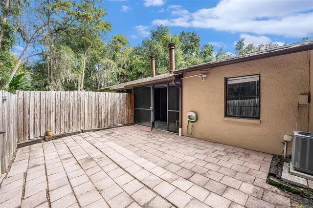 a backyard of a house with table and chairs