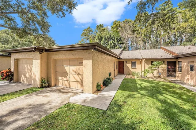 a view of a house with backyard and porch