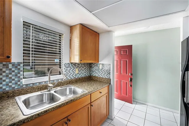 a kitchen with a sink and a refrigerator