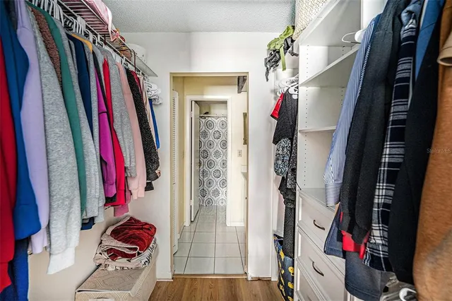 a view of walk in closet with clothes