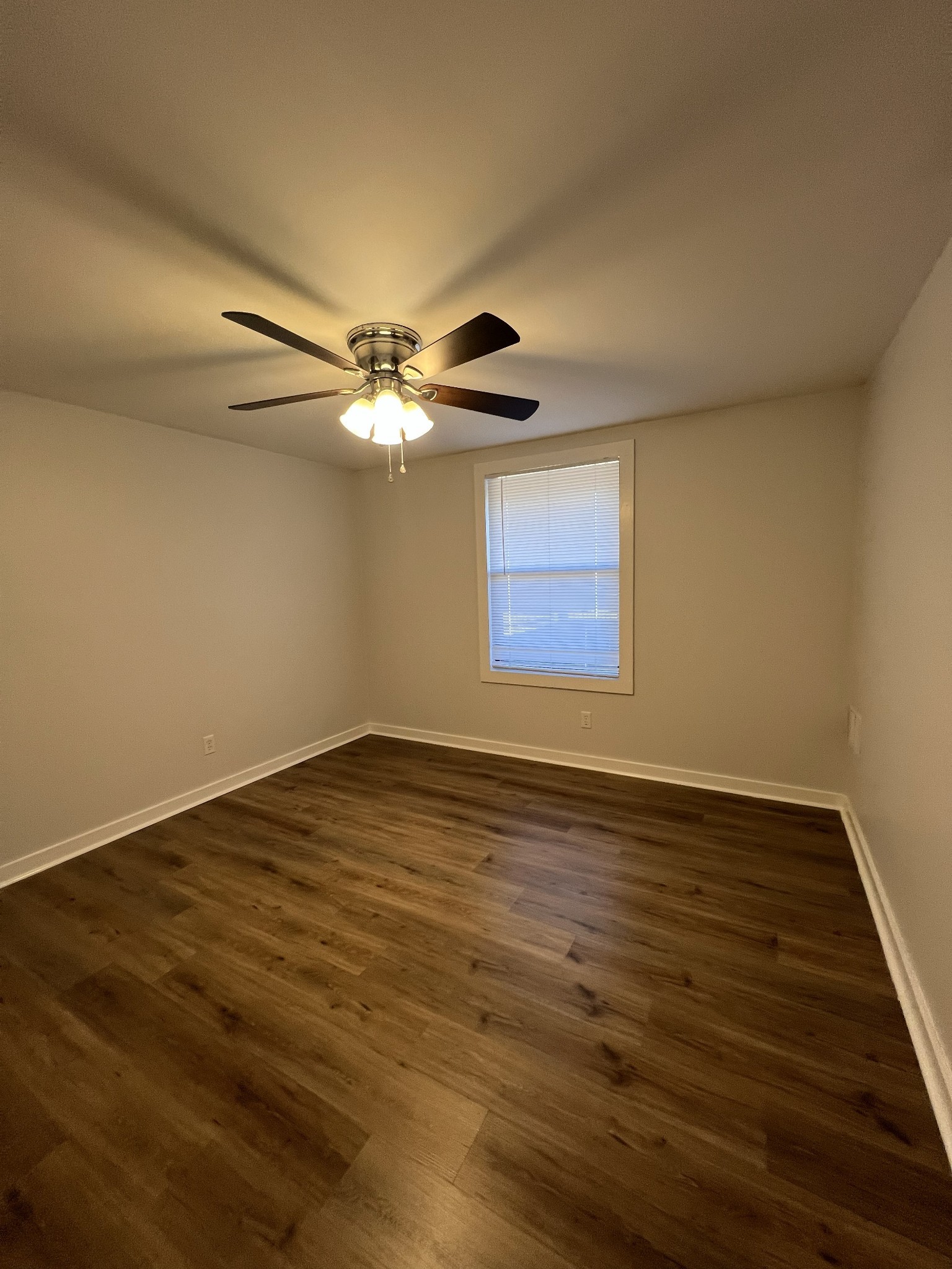 2421 Madison Street, Unit 13 Clarksville, TN 37043 - Photo 5 of 10 a view of an empty room with wooden floor and a window