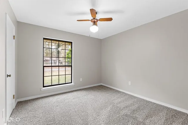 a bathroom with a granite countertop sink a toilet and a mirror