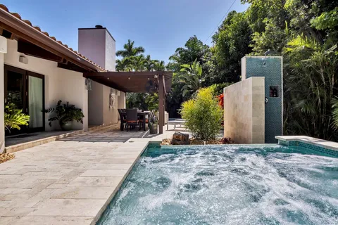 a view of a house with potted plants in front of it