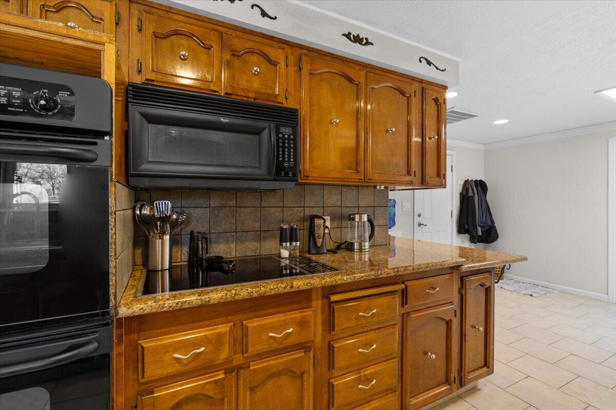 324 China Gulch Road Jacksonville, OR 97530 - Photo 14 of 45 a kitchen with granite countertop cabinets stainless steel appliances and a counter space