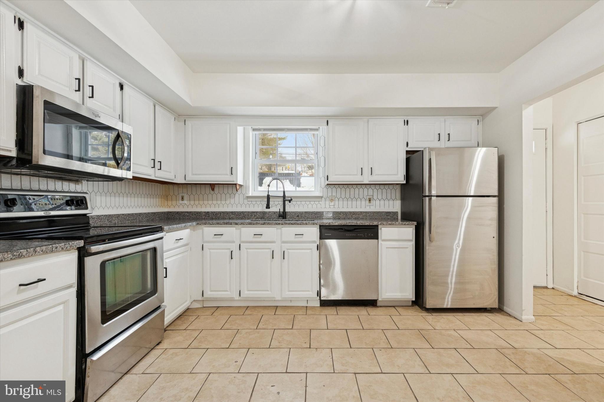 21 Cavendish Drive Ambler, PA 19002 - Photo 3 of 29 a kitchen with granite countertop a refrigerator stove top oven and sink