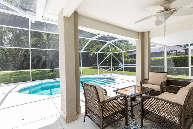 a view of a porch with furniture and floor to ceiling window