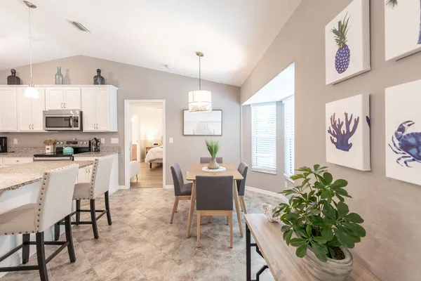 a dining room with furniture and window