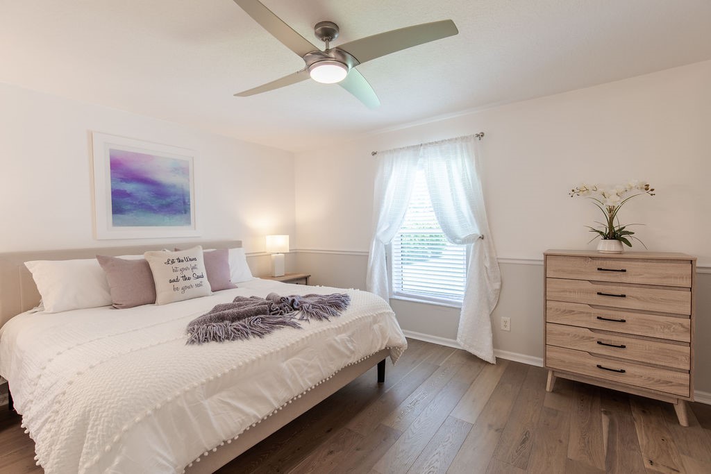 3673 2nd Place Southwest Vero Beach, FL 32968 - Photo 16 of 33 a bedroom with a bed a dresser and a window