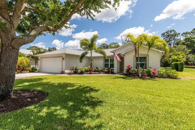 a view of a house with a backyard