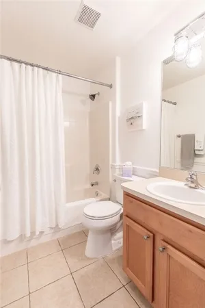 a bathroom with a double vanity sink toilet and a mirror