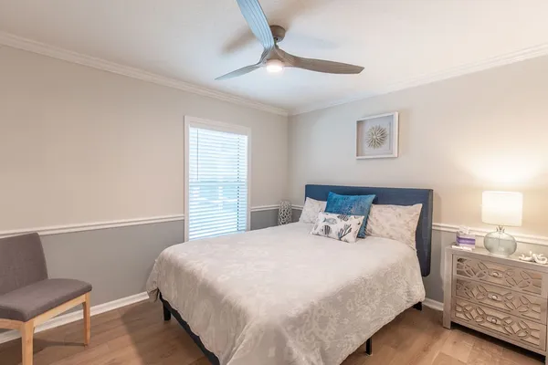 a bedroom with a bed and a night stand