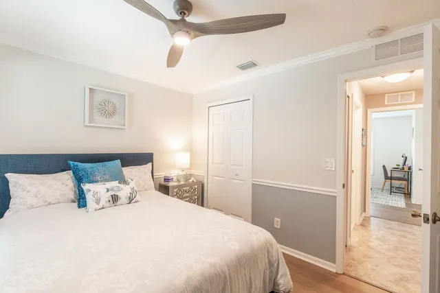 a bedroom with a bed and a view fan