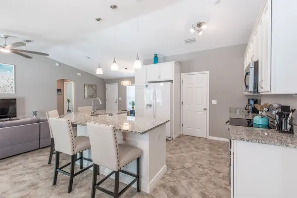 a large kitchen with a table and chairs